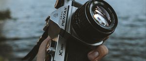 Preview wallpaper camera, hand, lens, landscape