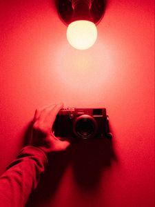 Preview wallpaper camera, hand, light bulb, light, red