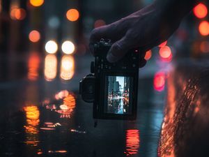 Preview wallpaper camera, hand, shooting, blur, neon