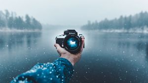 Preview wallpaper camera, hand, snow, lens