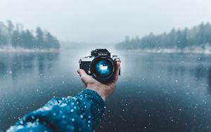 Preview wallpaper camera, hand, snow, lens