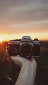 Preview wallpaper camera, hand, sunset, photographer