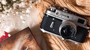 Preview wallpaper camera, lens, flowers, book, cloth