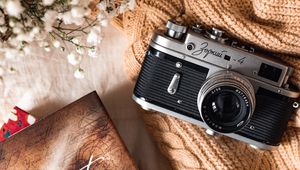 Preview wallpaper camera, lens, flowers, book, cloth