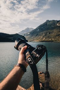 Preview wallpaper camera, lens, hand, mountains, focus