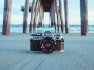 Preview wallpaper camera, pier, sand, blur