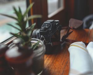 Preview wallpaper camera, plants, table, aesthetics