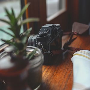 Preview wallpaper camera, plants, table, aesthetics