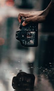 Preview wallpaper camera, snapshot, puddle, hand, reflection