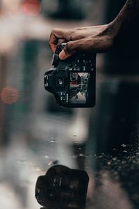 Preview wallpaper camera, snapshot, puddle, hand, reflection