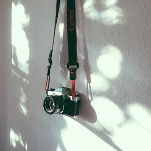 Preview wallpaper camera, strap, wall, shadow