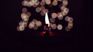 Preview wallpaper candle, fire, darkness, glare, bokeh