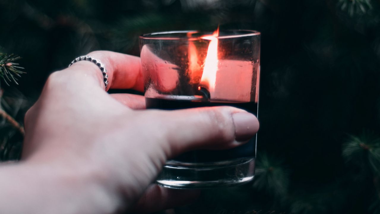 Wallpaper candle, hand, branches, spruce
