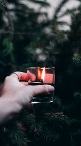 Preview wallpaper candle, hand, branches, spruce