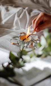 Preview wallpaper candle, match, hand, book, branch