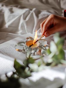 Preview wallpaper candle, match, hand, book, branch