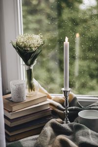 Preview wallpaper candle, window, bouquet, rain, books, plaid, cup