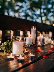 Preview wallpaper candles, glass, petals, table
