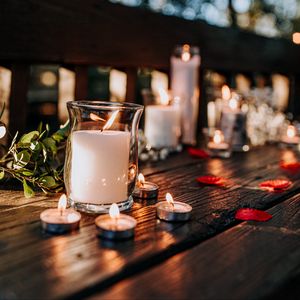 Preview wallpaper candles, glass, petals, table