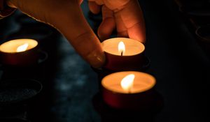 Preview wallpaper candles, hand, dark
