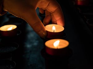 Preview wallpaper candles, hand, dark