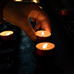 Preview wallpaper candles, hand, dark