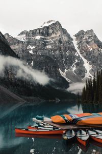 Preview wallpaper canoe, boats, lake, pier, mountains