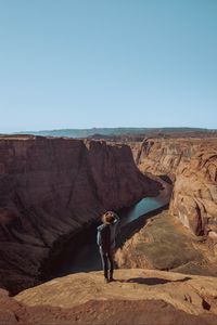 Preview wallpaper canyon, man, cliff, river, view