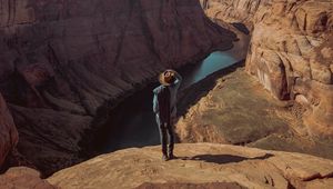 Preview wallpaper canyon, man, cliff, river, view