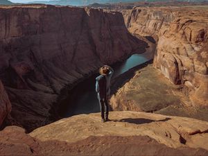 Preview wallpaper canyon, man, cliff, river, view