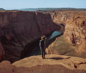 Preview wallpaper canyon, man, cliff, river, view