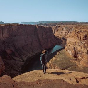 Preview wallpaper canyon, man, cliff, river, view