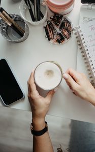 Preview wallpaper cappuccino, mug, hands, table, work, aesthetics