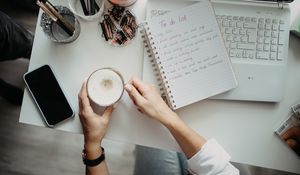 Preview wallpaper cappuccino, mug, hands, table, work, aesthetics