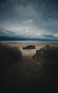 Preview wallpaper car, beach, sand, storm, coast