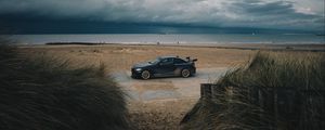 Preview wallpaper car, beach, sand, storm, coast