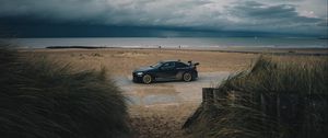 Preview wallpaper car, beach, sand, storm, coast