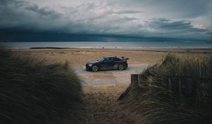 Preview wallpaper car, beach, sand, storm, coast