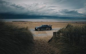 Preview wallpaper car, beach, sand, storm, coast