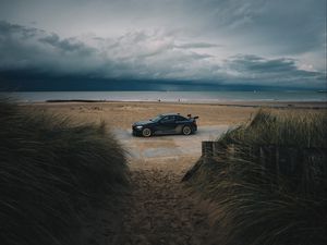 Preview wallpaper car, beach, sand, storm, coast