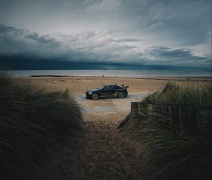 Preview wallpaper car, beach, sand, storm, coast