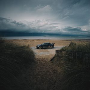 Preview wallpaper car, beach, sand, storm, coast