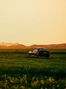 Preview wallpaper car, black, field, sunset
