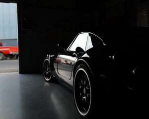 Preview wallpaper car, black, garage, darkness