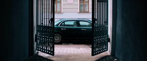 Preview wallpaper car, black, gate, building, street