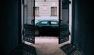 Preview wallpaper car, black, gate, building, street