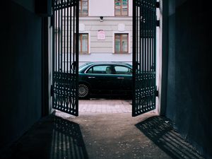 Preview wallpaper car, black, gate, building, street