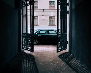Preview wallpaper car, black, gate, building, street