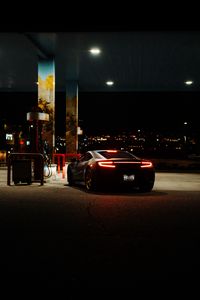 Preview wallpaper car, black, lights, back view, gas station