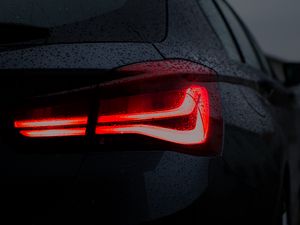 Preview wallpaper car, black, wet, taillight, backlight